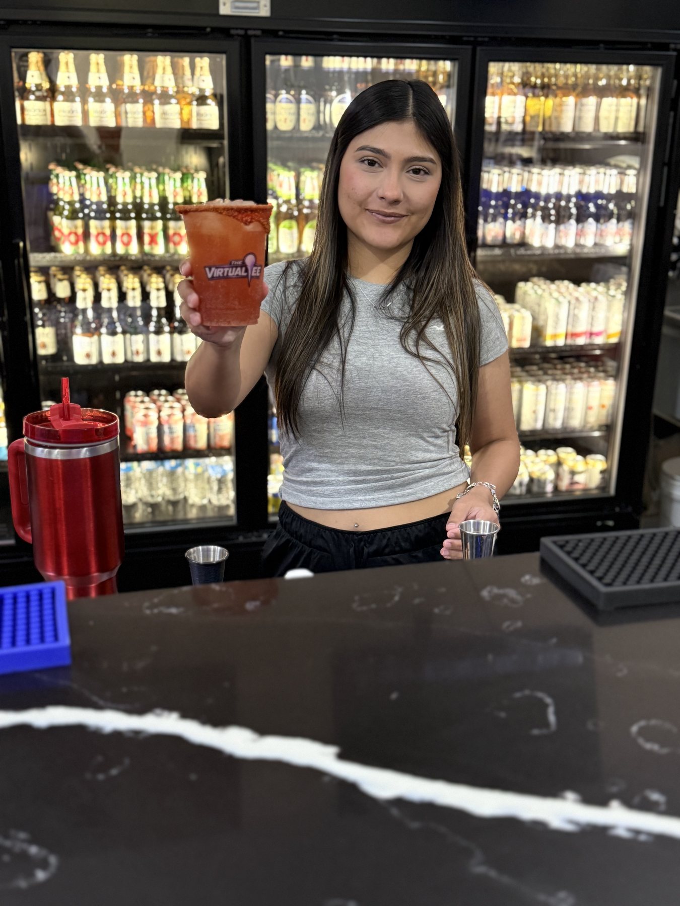 A drink being served at the bar inside The Virtual Tee